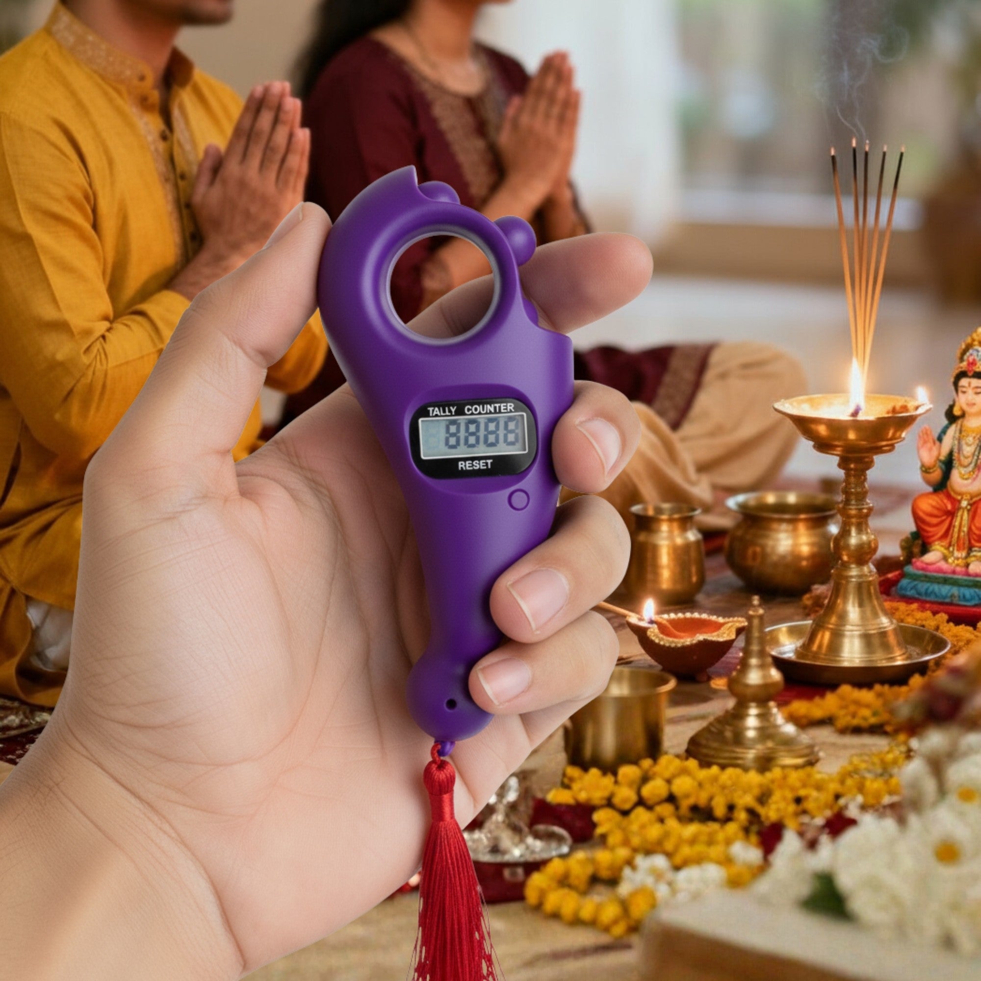 Hand holding a purple prayer counter with people praying in the background