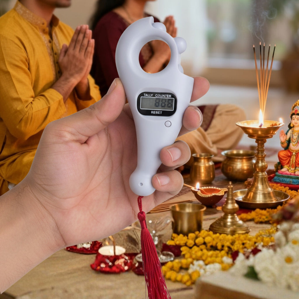 Digital tally counter held by a hand with people and religious items in the background